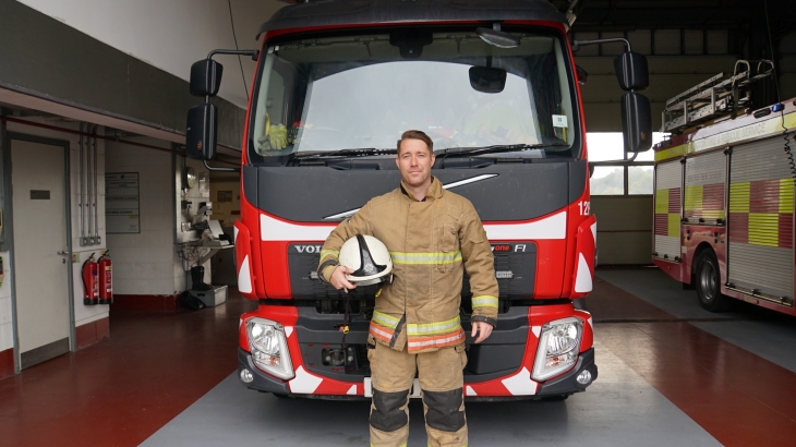 Bishop Auckland Watch Manager Jonner Robinson in front of a fire engine. 