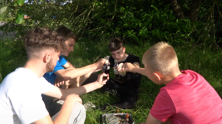 Fire Cadets sitting around a BBQ as they take part in a video highlighting the risks of wildfires. 