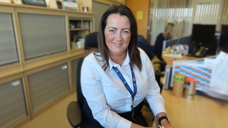 Nicola Stannard from the People and Organisational Development Team sitting at her desk. 