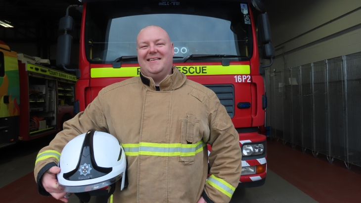 Watch Manager and Lead Core Trainer Matt Potter in front of a fire engine. 